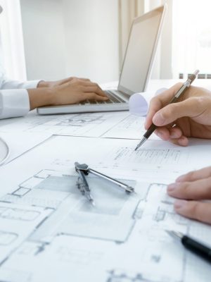 Image of engineer meeting for architectural project. working with partner and engineering tools on workplace vintage tone.